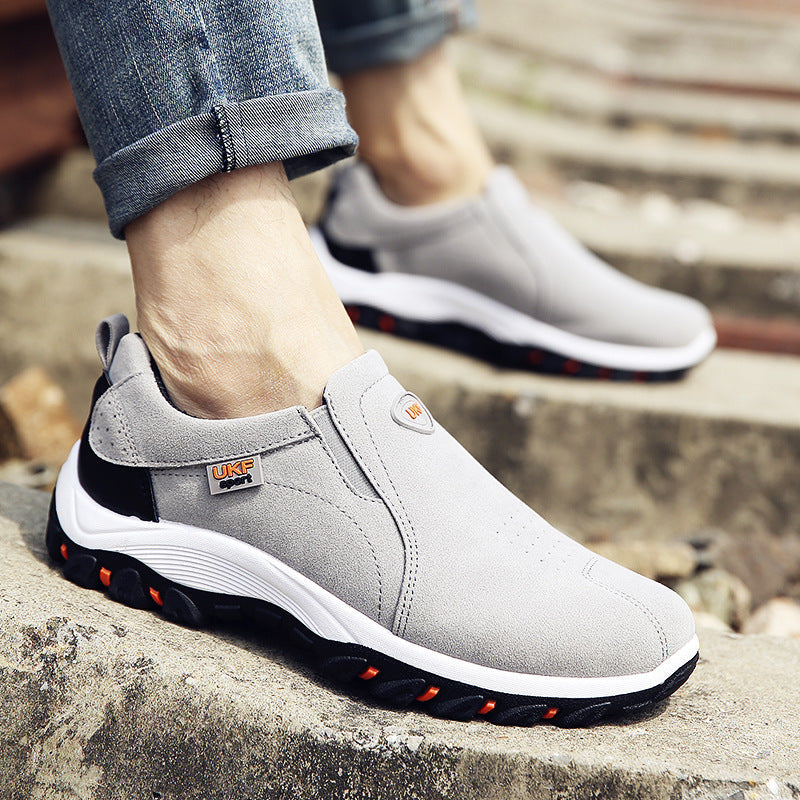 Light gray slip-on casual shoes with black and orange rubber soles worn with rolled-up jeans, designed as Mountain shoes outdoor men's shoes lazy shoes for easy wear.