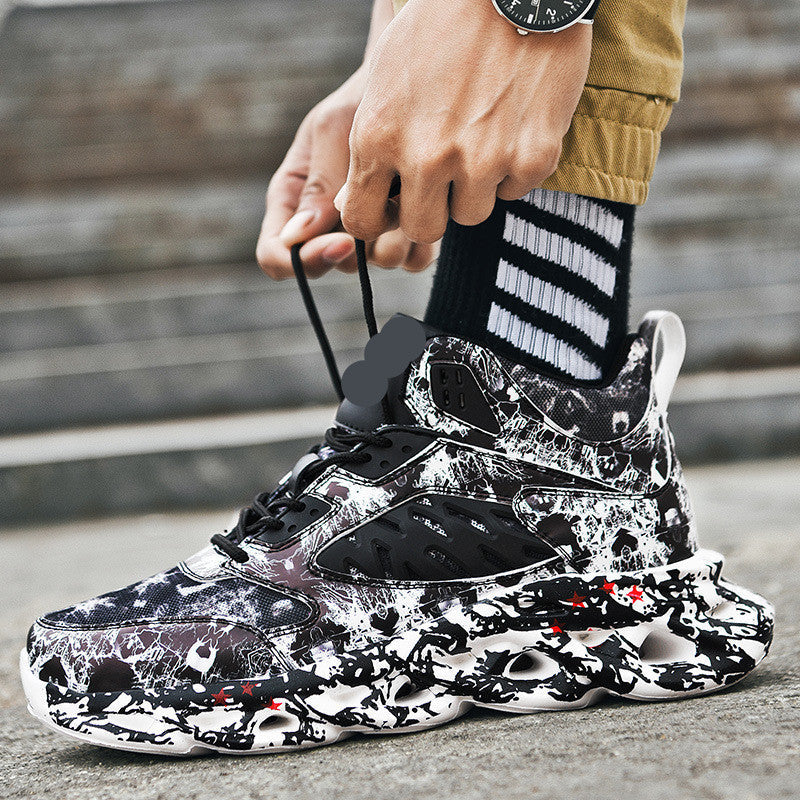 Close-up of a person tying black and white sneakers with an abstract camo pattern and chunky sole, showcasing the Trendy Camouflage Sports And Leisure Blade Old Shoes in a casual outdoor setting.