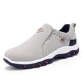 Gray slip-on Mountain shoes outdoor men's shoes lazy shoes with black and white sole and orange accents designed for casual outdoor activities.